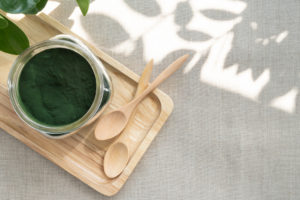 Spirulina with wooden spoons
