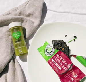 Probiotic green juice shot and moringa bar on table
